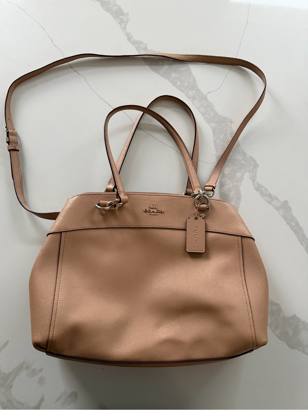 Coach Brooke Carryall is crafted from blush pink crossgrain leather